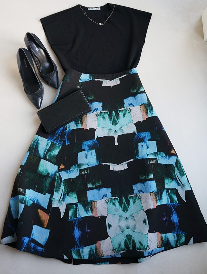 Flatlay with the black top “Michelle” & “Alexandra Frida” skirt