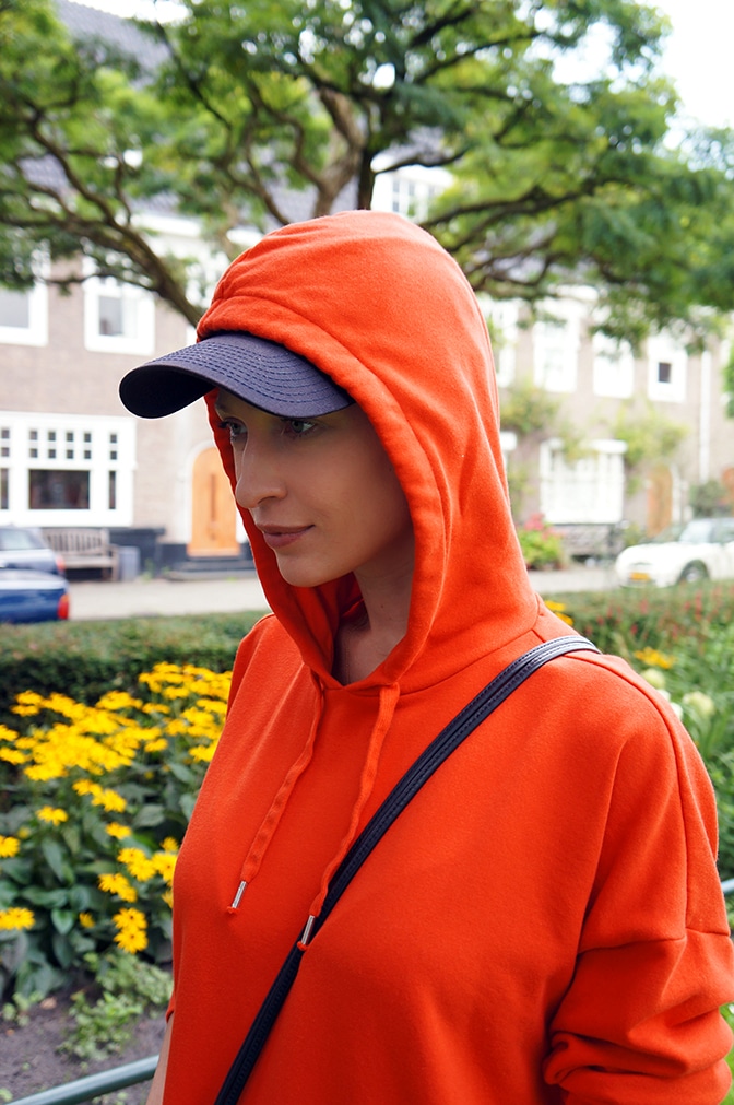 an orange sweatshirt dress with a hoodie